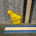 Yellow horse head shaped handmade crayon next to a ruler