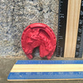 Red horse head in horseshoe handmade crayon next to a ruler