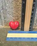 Red mini heart shaped handmade crayon next to a ruler